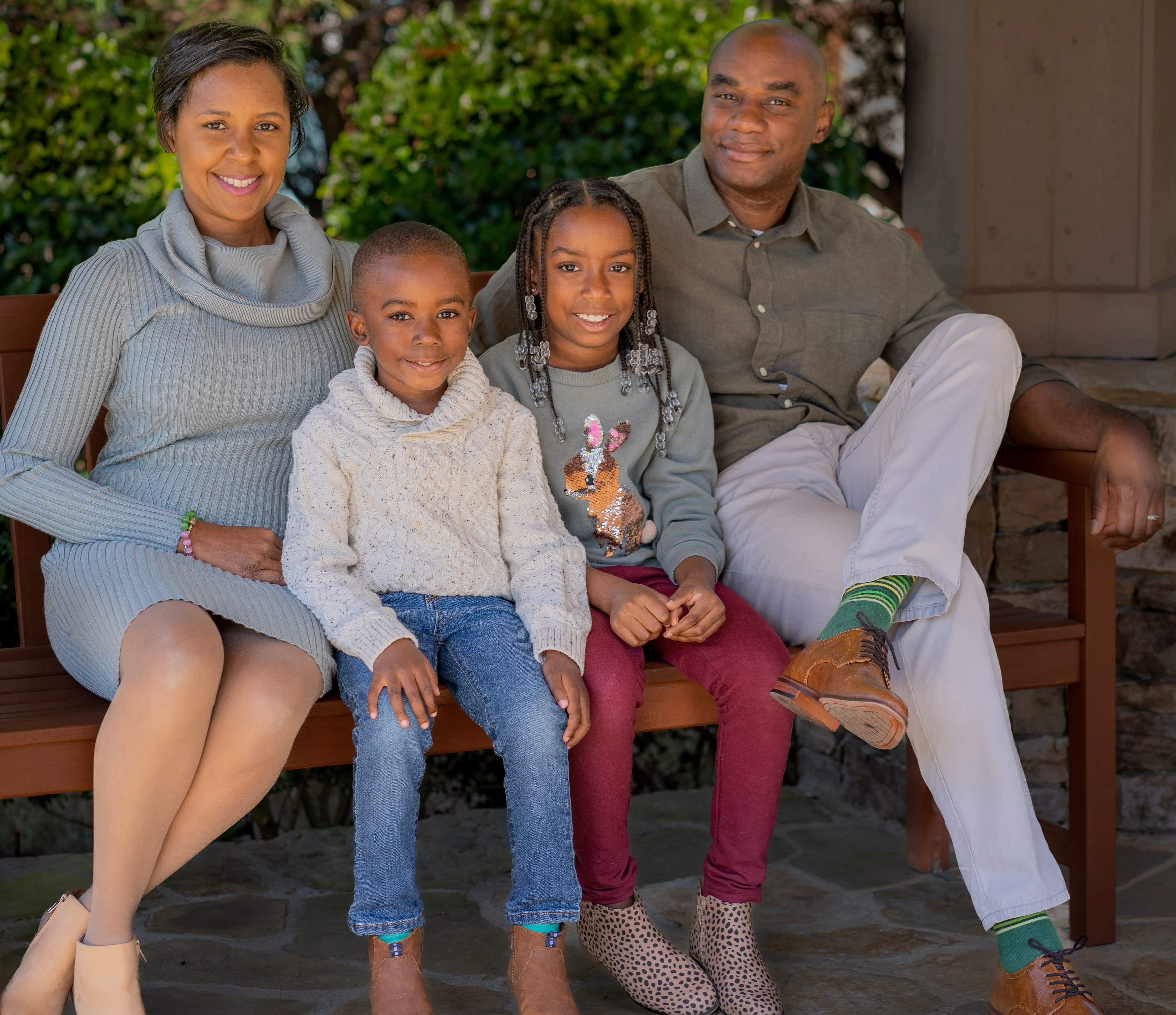 Family portrait of four on a garden bench
