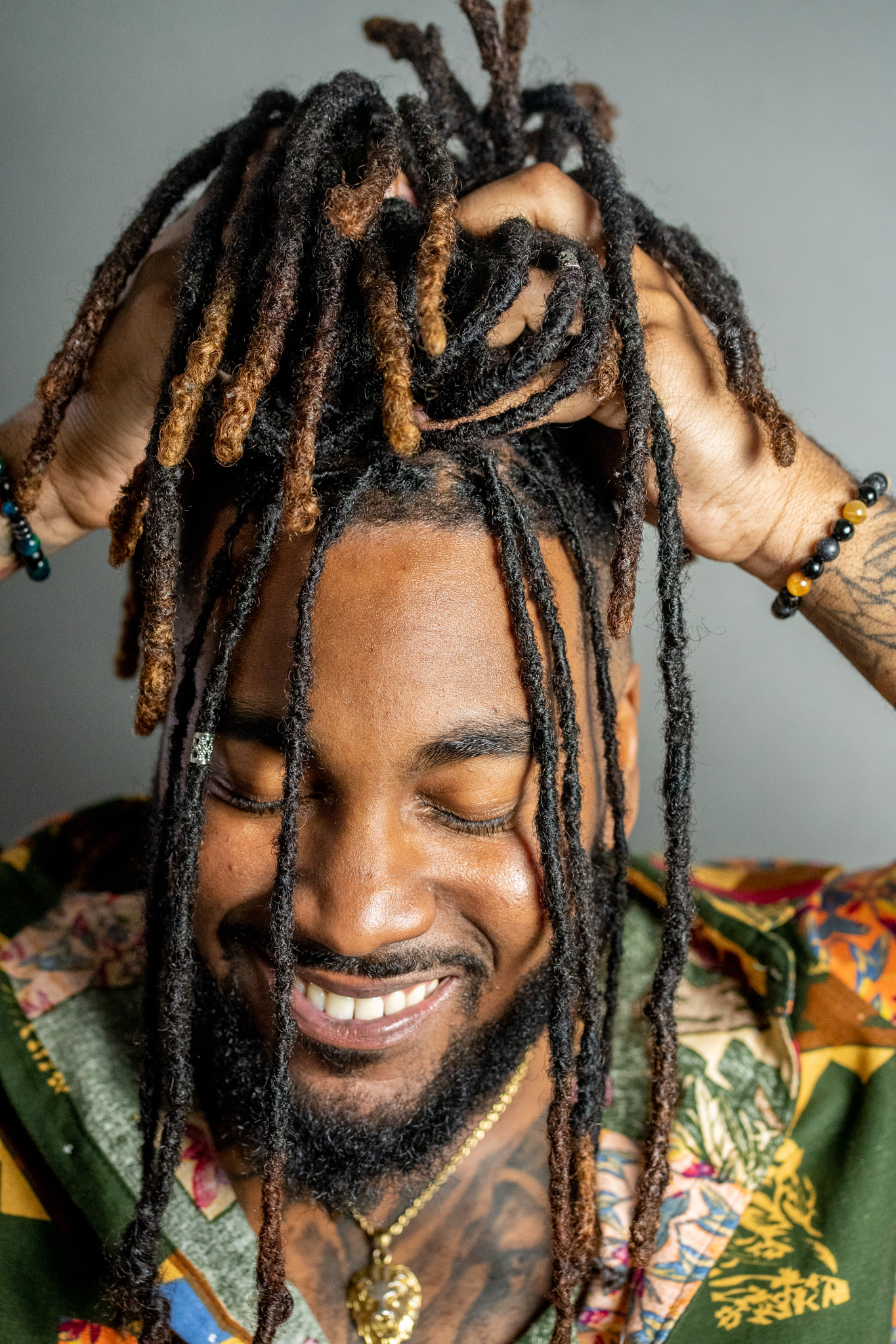 Portrait of a man with dreadlocks, smiling